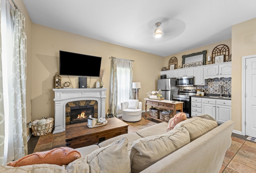 Living area featuring a ceiling fan and a fireplace