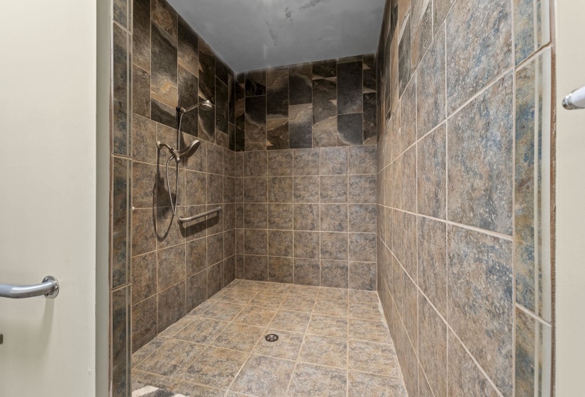 Full bath featuring a tile shower
