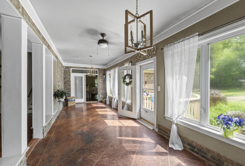 Unfurnished sunroom with french doors and a chandelier