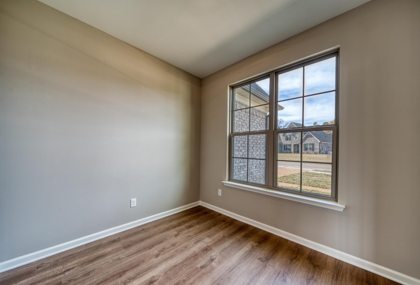 Spare room featuring baseboards and light wood-style flooring