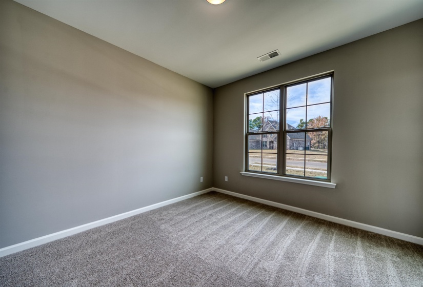 Spare room featuring baseboards and carpet flooring