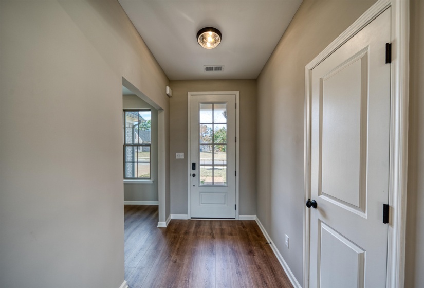 Doorway to outside with baseboards and wood finished floors