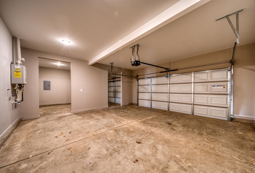Garage featuring electric panel and a garage door opener