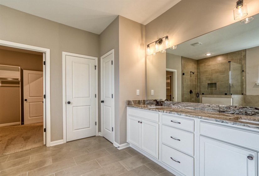 Bathroom with double vanity and a shower stall