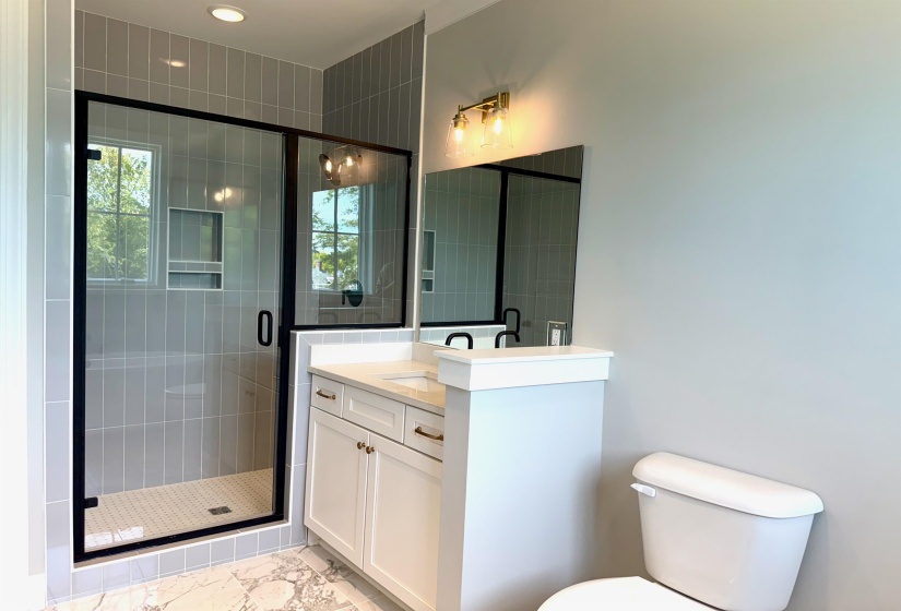 Bathroom with vanity, a stall shower, light marble finish flooring, and recessed lighting
