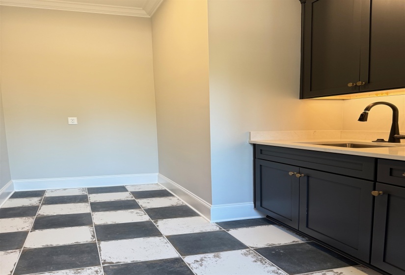 Bathroom featuring vanity and ornamental molding