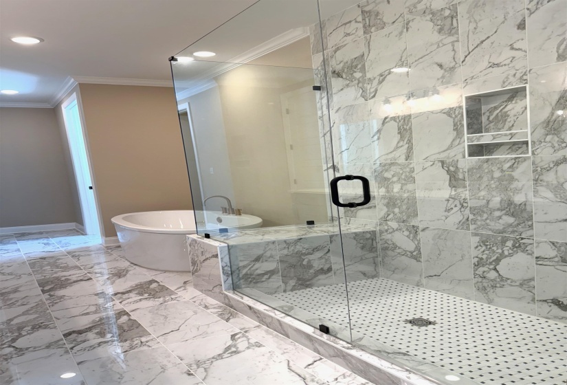 Full bath with ornamental molding, a freestanding bath, a marble finish shower, light marble finish flooring, and recessed lighting