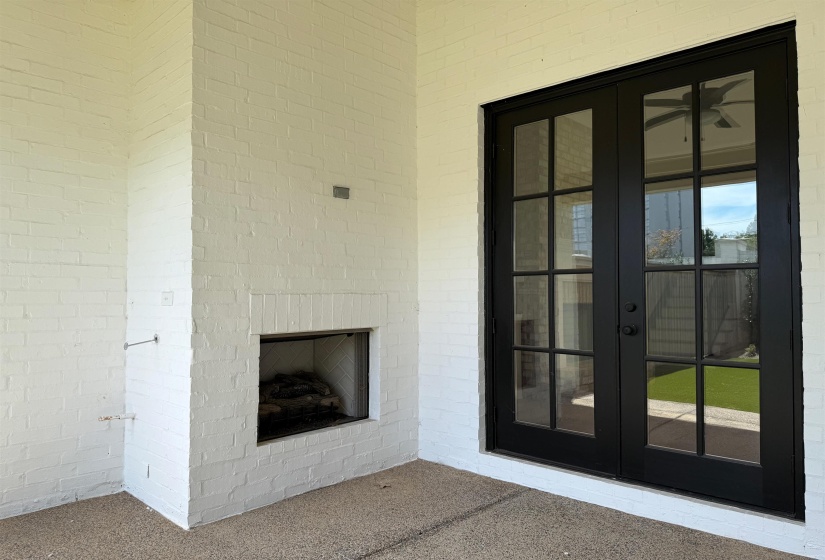 Entrance to property featuring french doors, a patio area, and brick siding