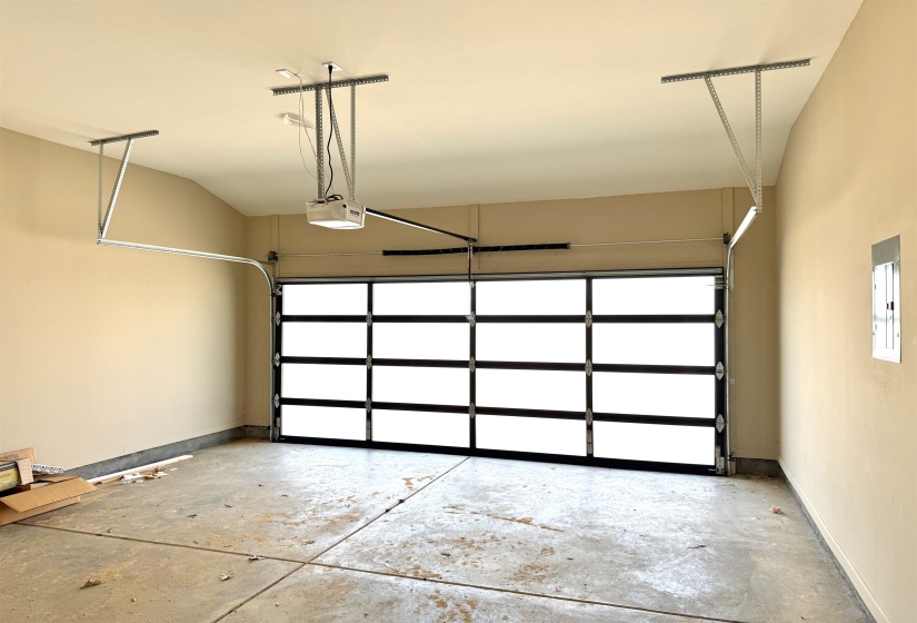 Garage with electric panel and a garage door opener
