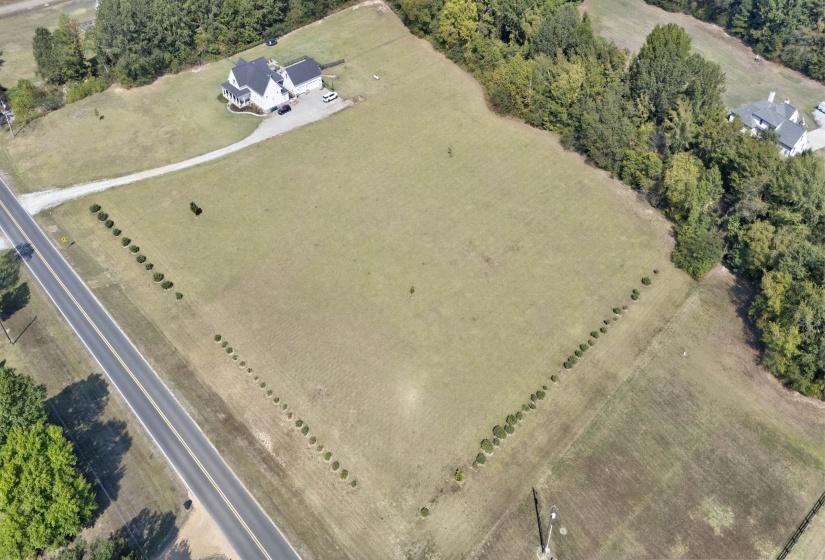 Aerial view of property and surrounding area featuring rural landscape