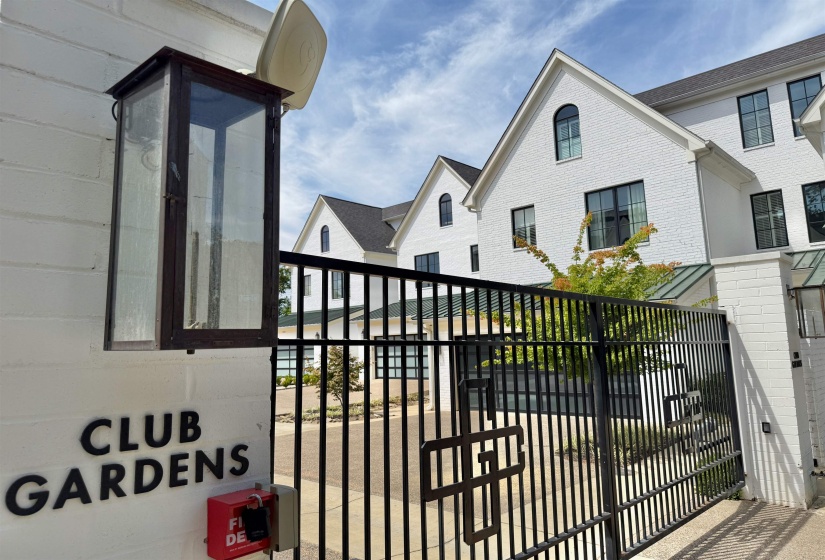 Gate featuring a balcony and a residential view