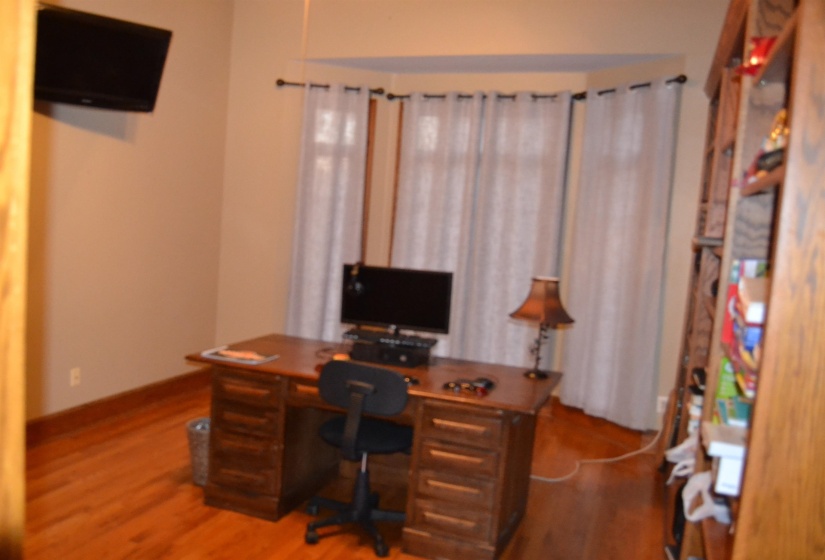 Office space with wood finished floors and baseboards