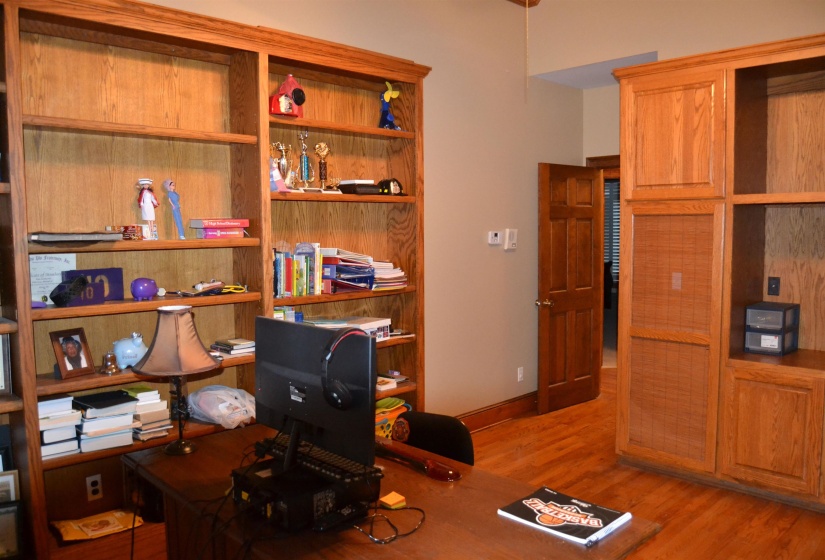 Office area featuring light wood-style floors and baseboards
