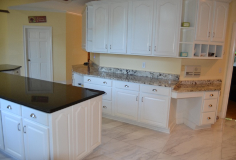 Kitchen featuring white cabinetry, a kitchen island, light marble finish floors, and open shelves