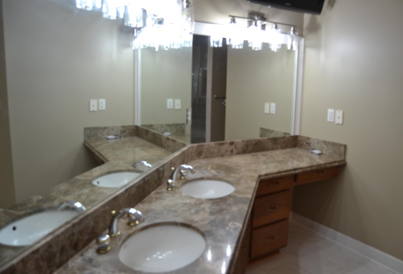 Bathroom featuring double vanity and light tile patterned floors