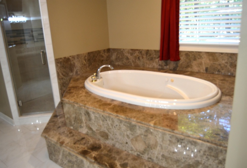 Full bathroom featuring a bath and a walk-in shower