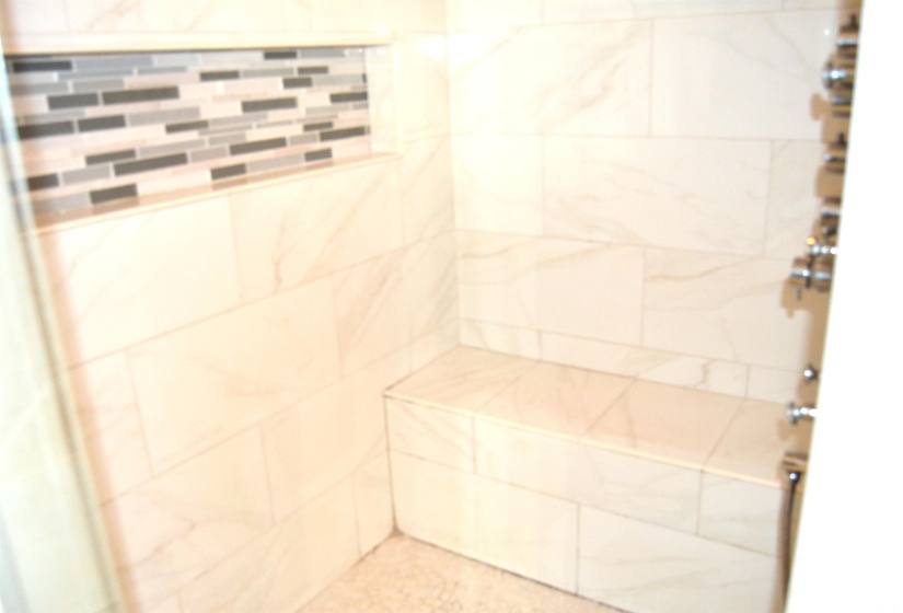 Bathroom view of a tile shower