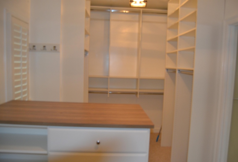 View of primary bedroom walk in closet