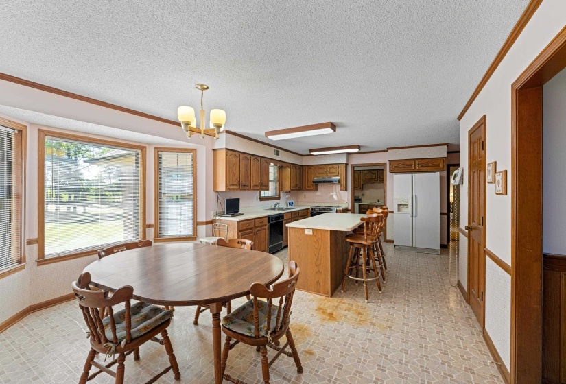 With natural light pouring in, this kitchen combines style and practicality. Ample counters give plenty of workspace, and the pantry ensures organized storage. The eat-in area offers a cozy spot to enjoy meals while overlooking the spacious grounds.