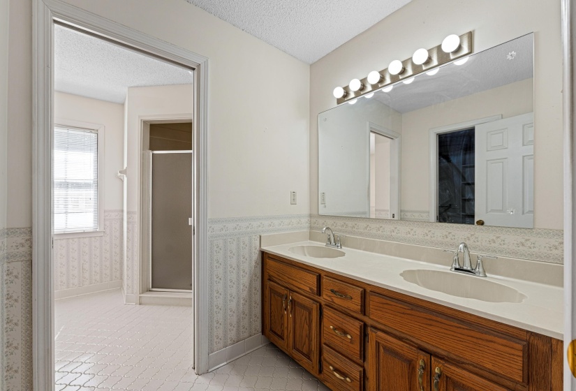 The primary bathroom features a wide double vanity with plenty of room for getting ready. On the wall opposite is the spacious walk-in closet that provides ample room to keep daily living comfortable and organized.