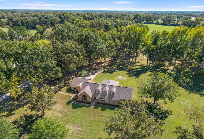 Expansive acreage stretches out in every direction, accented by mature trees and the calming rhythm of nature. It’s the kind of property where time slows down.