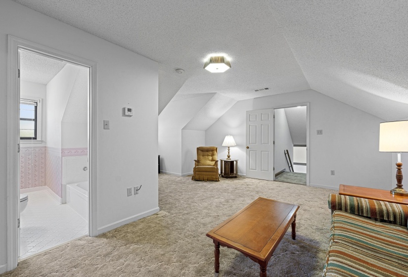With neutral walls and comfortable carpeting, this upstairs bonus room is a flexible space ready to meet your needs. Its size and open layout make it ideal for hobbies, entertainment, or casual lounging.
