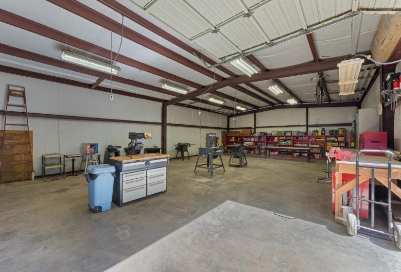 This expansive shop features durable concrete floors and extensive lighting, creating an ideal space for projects, vehicles, or storage. Its size and functionality make it a standout feature of the property.