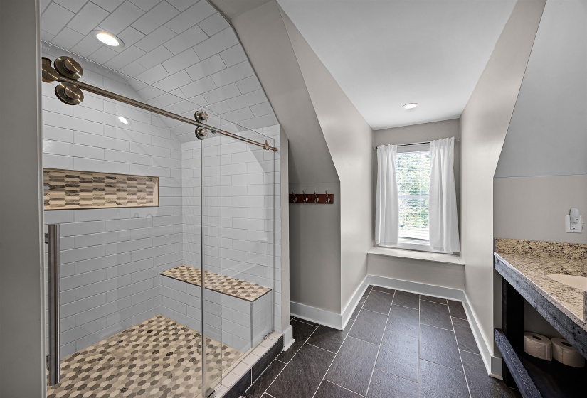 Bathroom featuring vanity, a stall shower, recessed lighting, and dark tile patterned floors