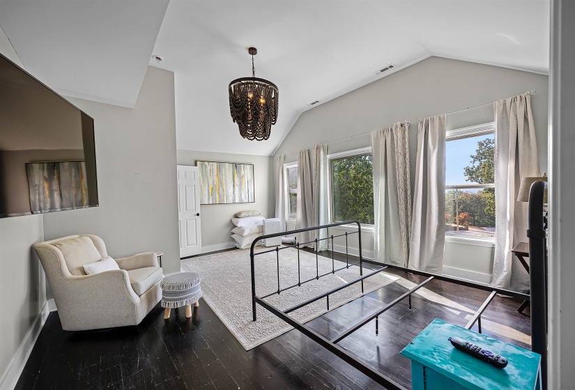 Foyer entrance featuring a chandelier, hardwood / wood-style floors, and vaulted ceiling
