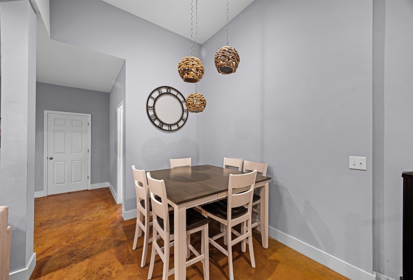 Dining room with finished concrete flooring and baseboards