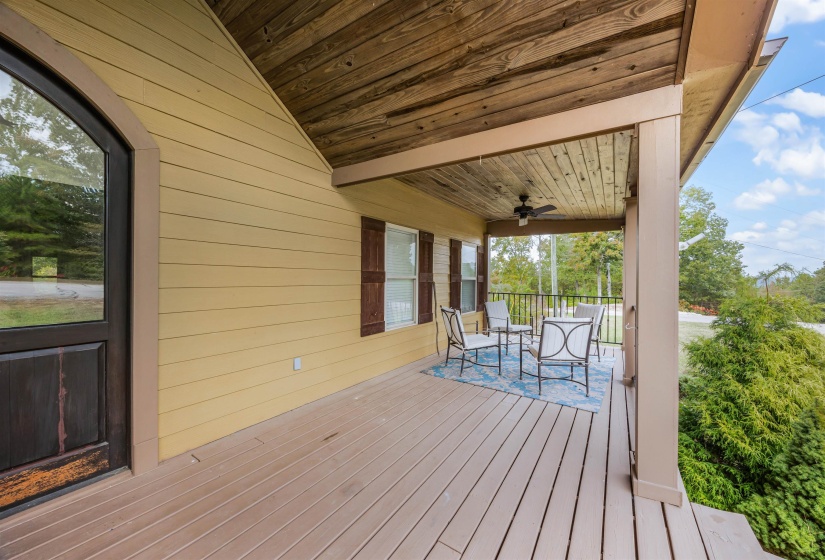 Wooden terrace featuring a ceiling fan