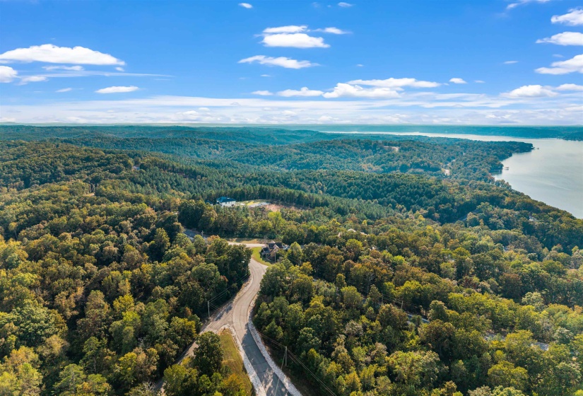 Aerial view of a heavily wooded area and a large body of water