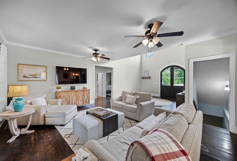 Living room featuring ornamental molding, french doors, wood finished floors, and a ceiling fan