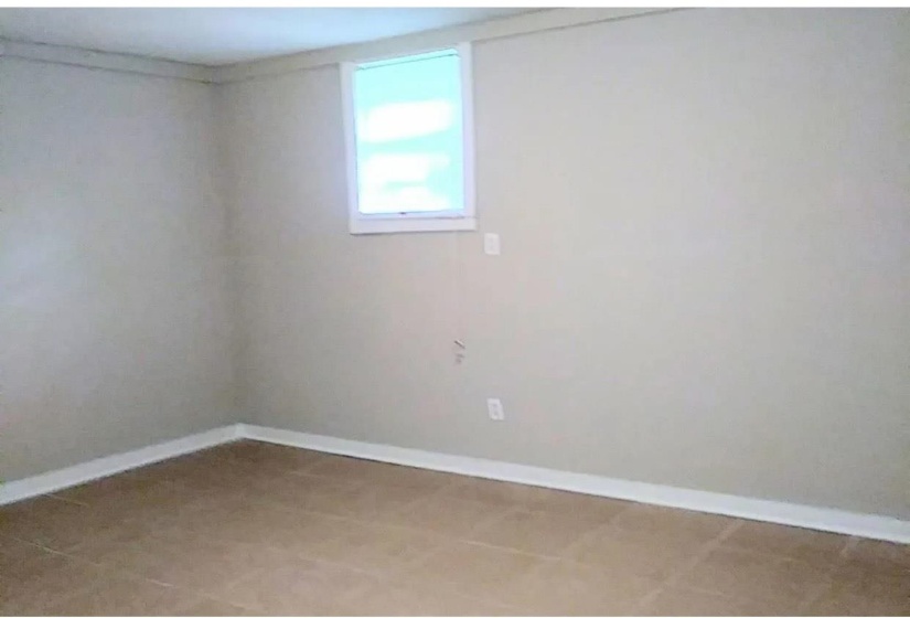 Unfurnished room featuring baseboards