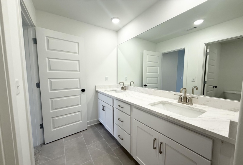 Bathroom with double vanity and recessed lighting