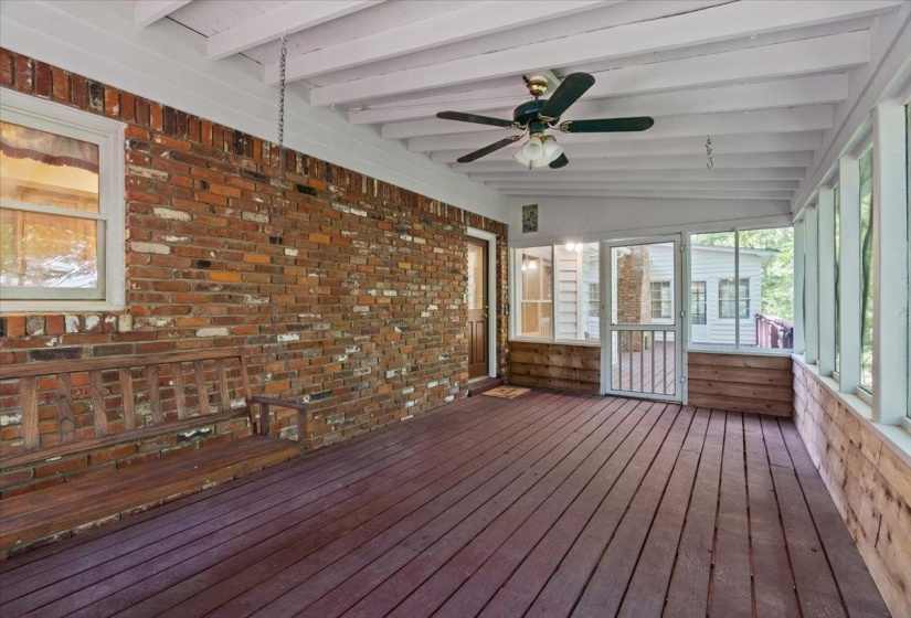 Deck featuring a sunroom and ceiling fan