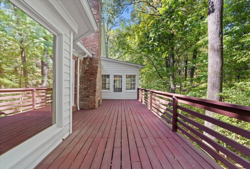 Wooden deck featuring view of wooded area