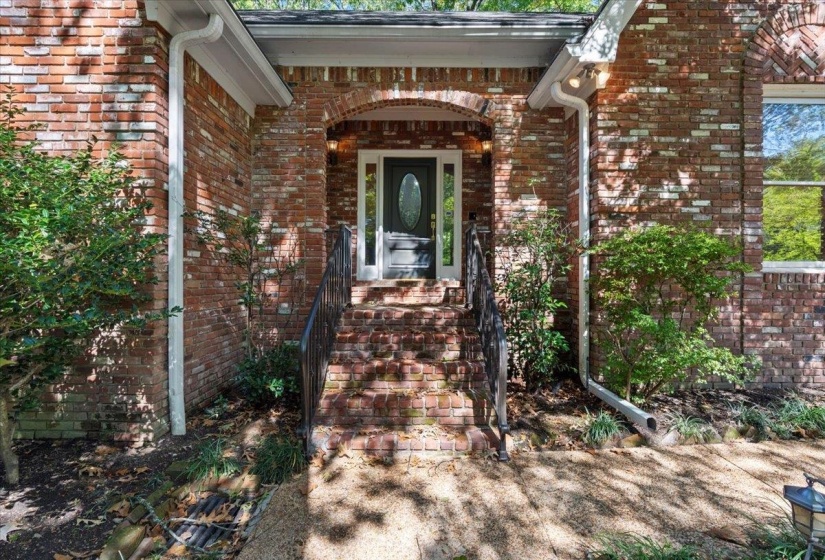 View of exterior entry with brick siding