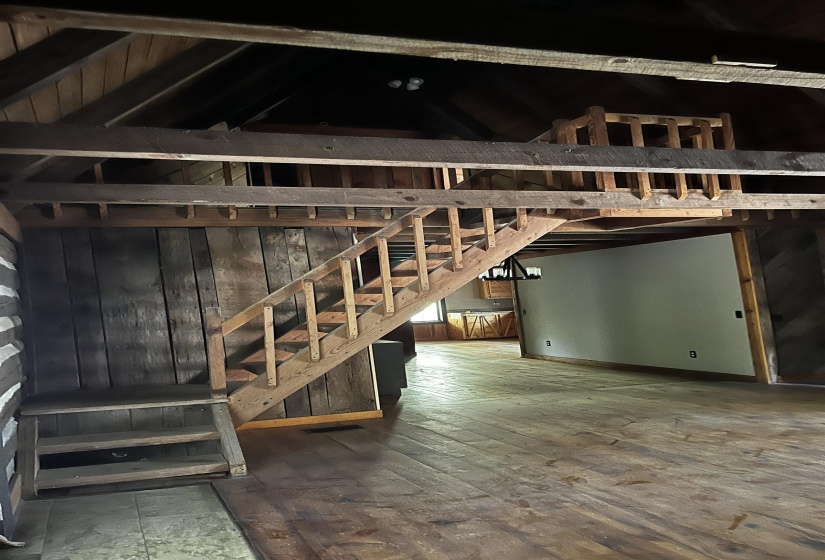 Basement with baseboards and stairs