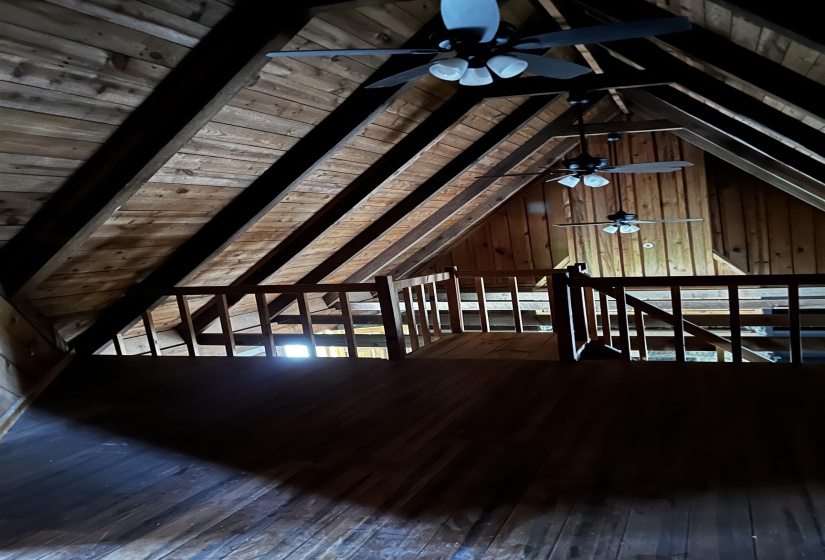 Additional living space featuring hardwood / wood-style flooring, wooden ceiling, ceiling fan, and wooden walls