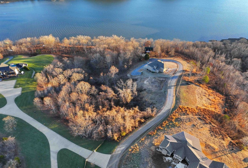 Birds eye view of property with a water view