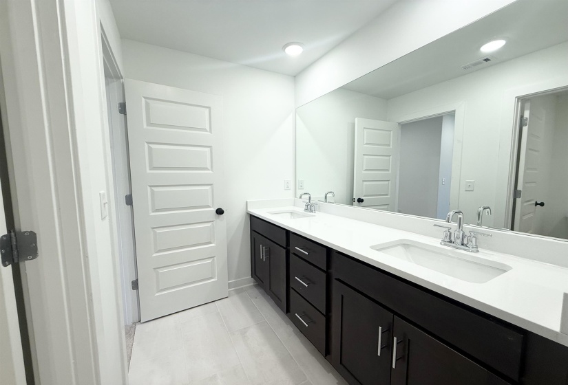Full bath with double vanity and recessed lighting