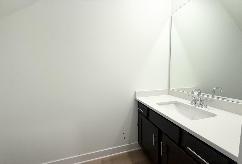 Bathroom featuring vanity and baseboards