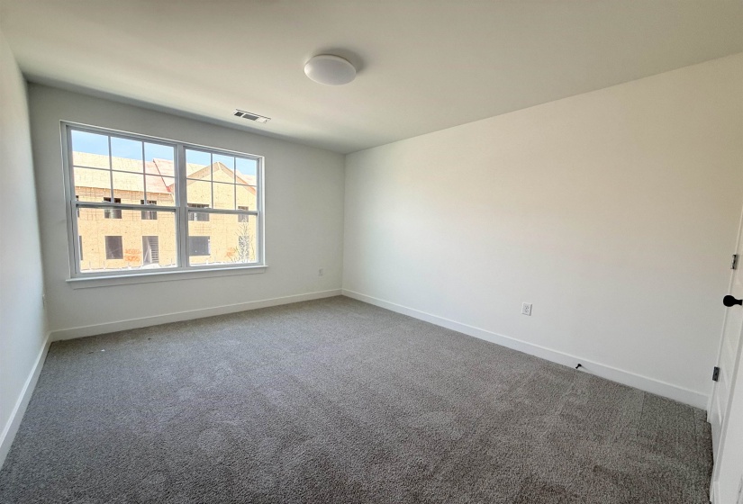 Carpeted spare room with baseboards