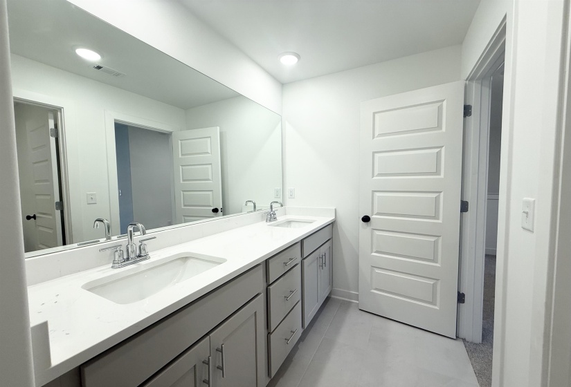 Bathroom with double vanity and recessed lighting