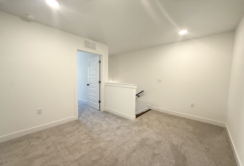 Unfurnished room with light colored carpet, recessed lighting, and a smoke detector
