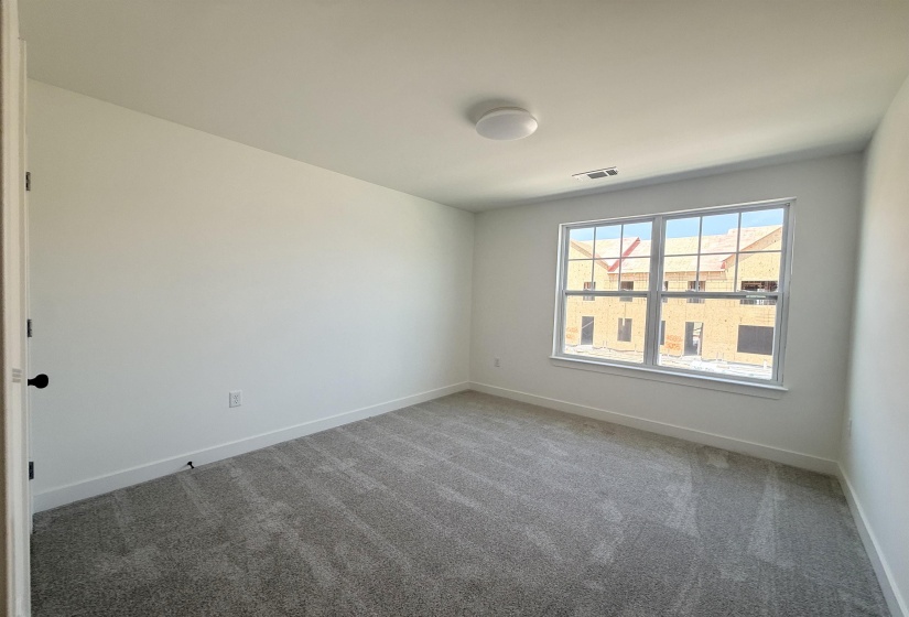 Spare room featuring carpet floors and baseboards