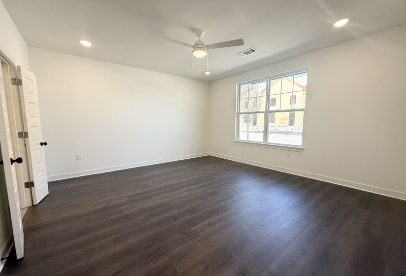 Spare room with recessed lighting, dark wood-type flooring, and a ceiling fan