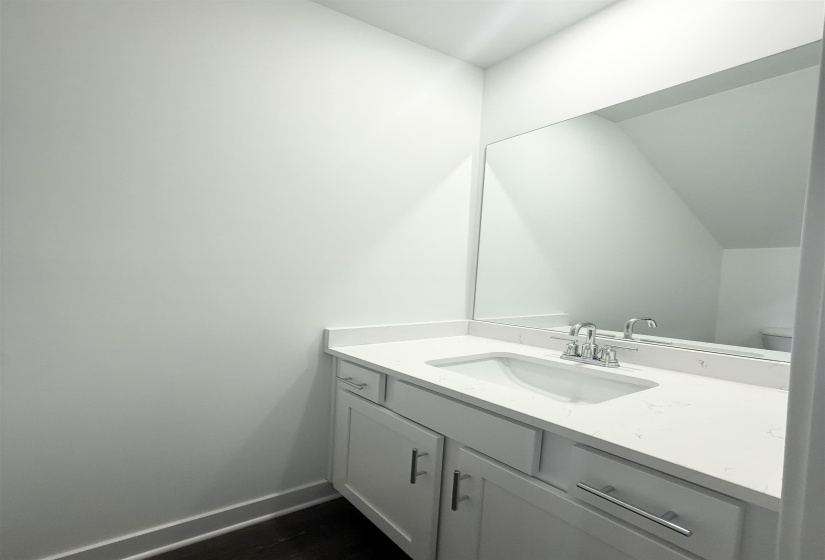 Bathroom with vanity and baseboards