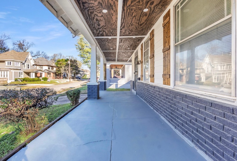 Covered porch featuring a residential view